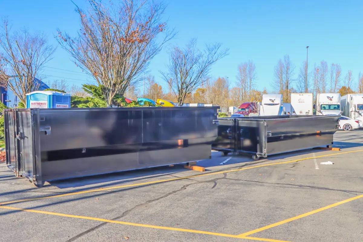 Professional dumpster rental service with roll-off container on residential driveway in Pahrump
